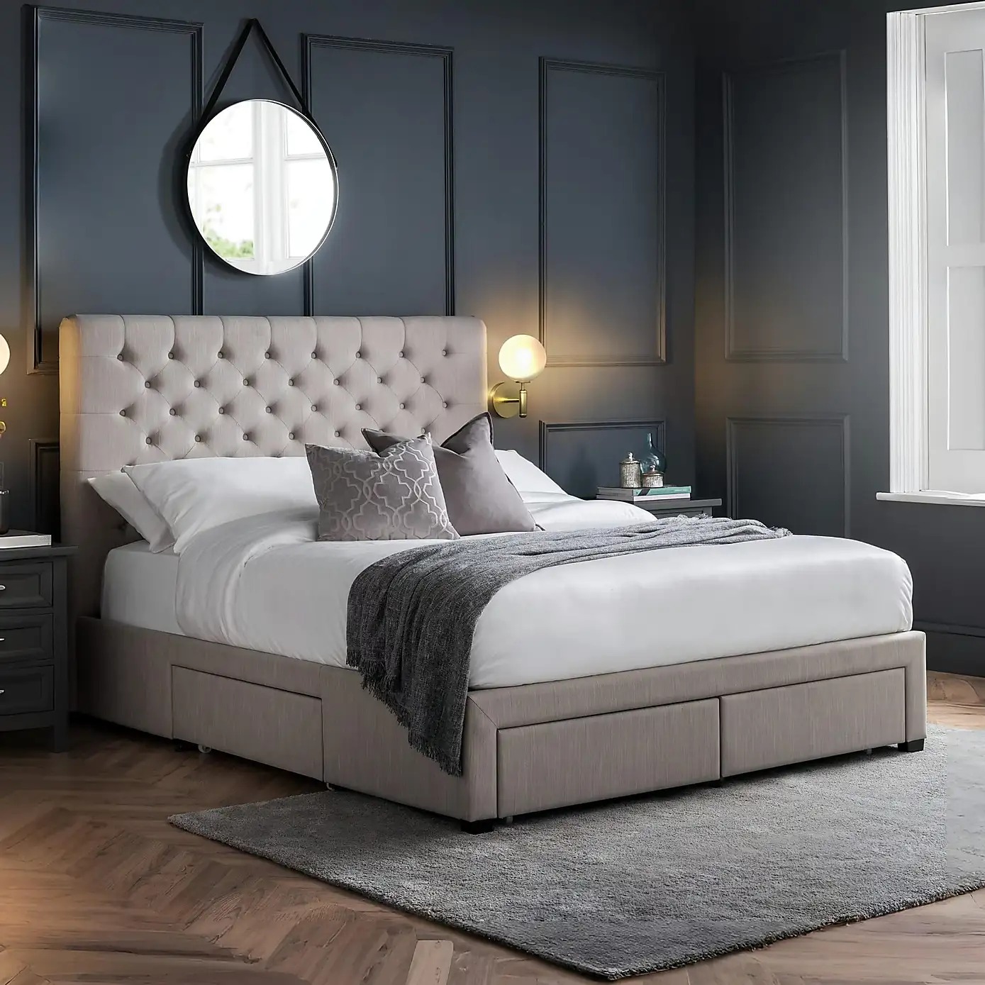 Light grey button-tufted upholstered divan bed with storage drawers and matching headboard.